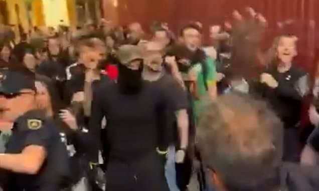 Violence erupts between right and left-wing protesters in Spanish city days after socialist government approved plans to give 500,000 migrants legal status