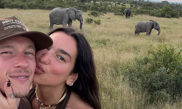 Dua Lipa cosies up to her fiancé Callum Turner on safari in South Africa as couple pose for snaps with elephants and zebras