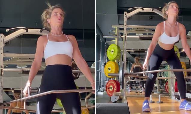 Pregnant Vogue Williams shows off her bump in a crop top as she lifts weights in the gym after revealing she suffered 'awful and heartbreaking' miscarriages