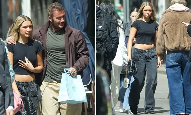 David Beckham drapes his arm around daughter Harper, 14, as she clutches £3,100 bag during NYC shopping trip