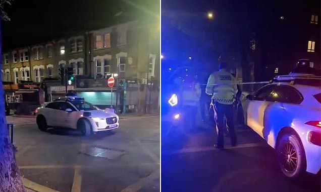 Moment 'driverless' Waymo car being tested in London careers into a taped-off crime scene - but the firm insists it was HUMAN error