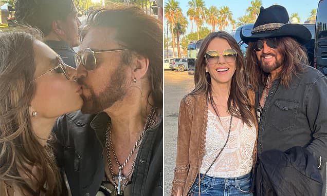 Elizabeth Hurley and Billy Ray Cyrus share a passionate kiss as actress supports singer at country music festival Stagecoach