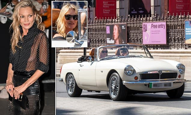 Kate Moss indulges her love of vintage cars as she is spotted zipping around London in classic British convertible