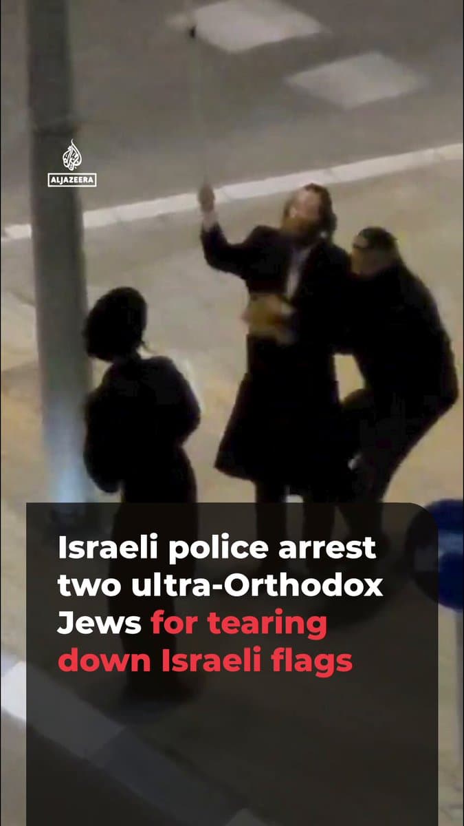 Video shows two ultra-Orthodox Jews tearing down Israeli flags from streetlight poles in Beit Shemesh, drawing protests from passersby. Israeli media reports said two people were arrested over the incident.