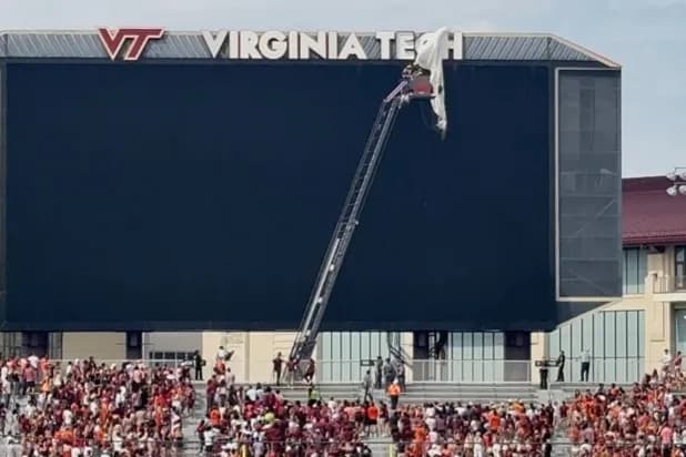 Skydiver Left Dangling When Parachute Snags on Stadium Video Board